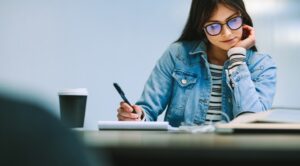 Young female student studying at a desk in a university setting