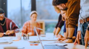 A diverse group of people around a table in a planning workshop.