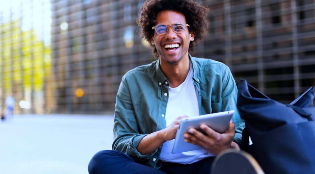 Smiling young man using a tablet device