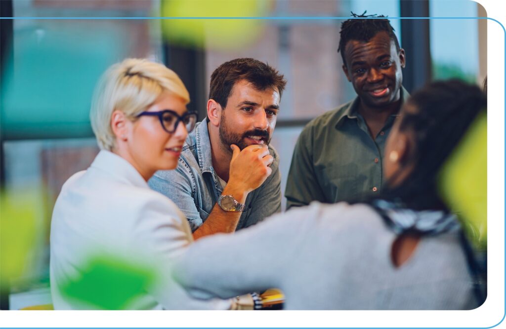 A group of professionals of different gender and ethnicity in a face-to-face meeting.