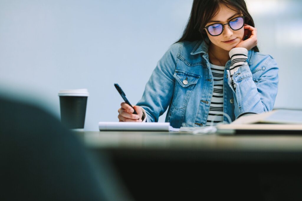 Female student in classroom working with a textbook